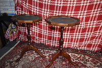 Front view of both wooden side tables on red patterned backdrop