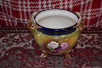 Porcelain footed bowl with ornate gold handles and feet, showing yellow gradient body and cobalt blue rim