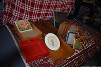 Photo showing ten assorted items including wooden trays, picture frames, a decorative plate, floral framed print, and a boxed item.