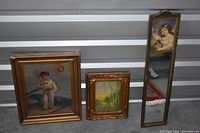 Wide view of three items: two framed paintings and one framed mirror