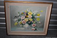 Photo of framed floral painting with yellow tulips, pink and white roses in a vase