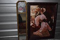 Two vintage framed pictures and one vertical mirror displayed together showing condition and style