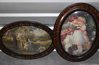 Two oval framed art pieces with detailed vintage images of children and women in natural and domestic environments.