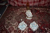 Full view of porcelain lamp and two wall plaques on oriental carpet