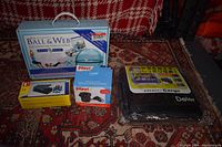 Overview of all items in lot including Ball & Web workout set, battery charger, car organizers, air pump