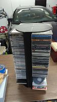 Full view of the 4-sided CD tower packed with numerous CDs, displaying the quantity and organization of the lot.