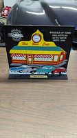 Front view of the Hot Rod Award plaque with a colorful enamel design of a diner, three classic cars, and a round clock showing the award details.