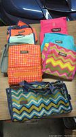 View of all 8 Packit insulated freeze and go bags in assorted colors and patterns