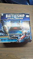 Original boxed Star Wars themed Milton Bradley electric Battleship game with box top showing graphics of starfighter and game screen.