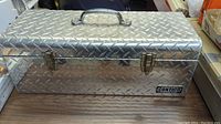 Exterior photo of Contico aluminum diamond plate toolbox with handle and latches visible.