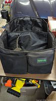 Large black vehicle organizer bag with carry handles and outer pocket with MRIVE logo.