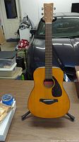 Front view of Yamaha 3/4 size acoustic guitar on stand