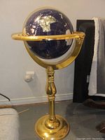 Full view of globe on brass stand