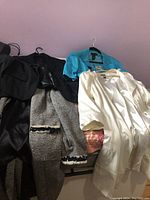 Five jackets on hangers and draped on chair showing colors and styles