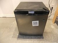 Front view of the Danby mini fridge with stainless steel door and black top panel.
