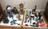 Photo showing the full assortment of figurines spread in two boxes on floor, showing diversity and scale.