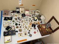 Overview of table with assorted costume jewelry and jewelry box