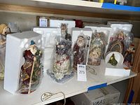 Shelf display of Jim Shore Heartwood Creek figurines in styrofoam and plastic wrap