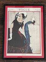 Frontal image of framed Vogue magazine cover print, showing a woman in black dress and a peacock on pedestal, 13x17 inches
