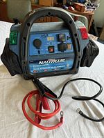 Full view of the Motomaster Nautilus Recreational Power Pack with red and black battery clamps and carry handle.