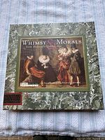 Closed Green marbled box with label showing 17th Century Dutch Golden Age painting with people in period costume