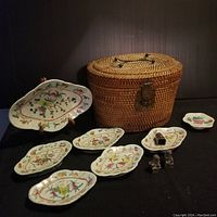 Overview of lot: dishes arranged around woven basket, cloisonne ring between, foo dog seals at front