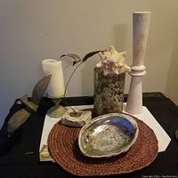 Full lot of vintage beach-themed decorative items including abalone shell, metal birds, etched vase, tall candlestick, and candle on holder.