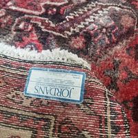 Close-up of underside label showing Jordan's Furniture Company tag and wool backing.