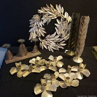 Overall lot showing various metal decorative candle holders and a metal wall wreath in a circular leaf design with crystals.