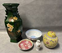 Full view of all ceramics in lot showing vase, ginger jar, two bowls, and small vase.