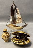 Overall view of the sailboat, snuff bottle, and clam shell diorama together