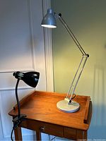 Photo showing both desk lamps on wooden surface, LED lit, revealing size and style.