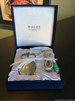 Vintage silver plated computer mouse inside a navy blue presentation box with white satin lining and Wallace Silversmiths branding on the lid.