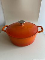 Front angled view of the orange Lagostina Dutch oven with lid on.