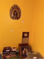 Image showing the Buddha wall hanging and framed prints and poster leaning against the wall.
