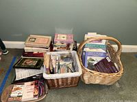 Wide view of the collection spread on floor including books and baskets with books and CDs.
