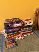 Stack of books touching on spiritual, sexual themes plus CDs in cases