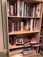 Whole bookshelf featuring multiple genres including romance, biography, fiction, gardening, self help, religion, diet.
