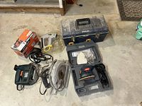 Lot layout with circular saw, jig saw, drill, mouse sander, and toolbox visible.