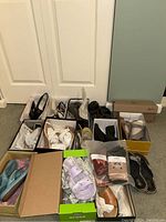 Overview of multiple boxed women's shoes and winter socks on floor.