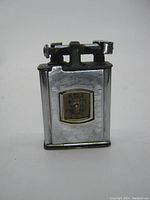 Front view showing polished silver metal swing arm lighter body with integrated square Erax Swiss watch on front and swing arm mechanism on top.