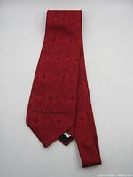 Full view of folded red Ralph Marlin tie with tonal tattoo pattern and Harley-Davidson branding.