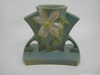 Front view of the Roseville Clematis vase showing floral relief and glaze color.