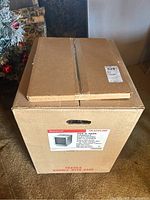 Two sealed cardboard boxes, one stacked on top of the other, labeled Honeywell F59 A 1026 Console Electronic Air Cleaner with specifications and wood grain cabinet image.