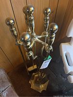 Photo of brass fireplace tool set with round ball finials and matching stand base