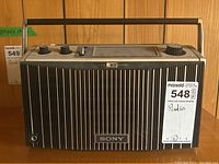Front view of vintage Sony table top radio showing large vertical grille, Sony logo, and carrying handle on top.