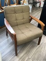 Armchair angled showing wood frame, armrests and seat cushion