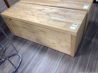 Full view of the wood storage bench showing the rectangular shape and flat top surface.