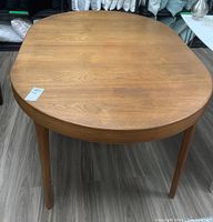 Top view of oval extendable teak dining table with center leaf installed