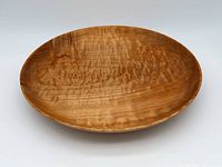 Full view of the oval-shaped maple bowl showing the natural wood grain and finish.